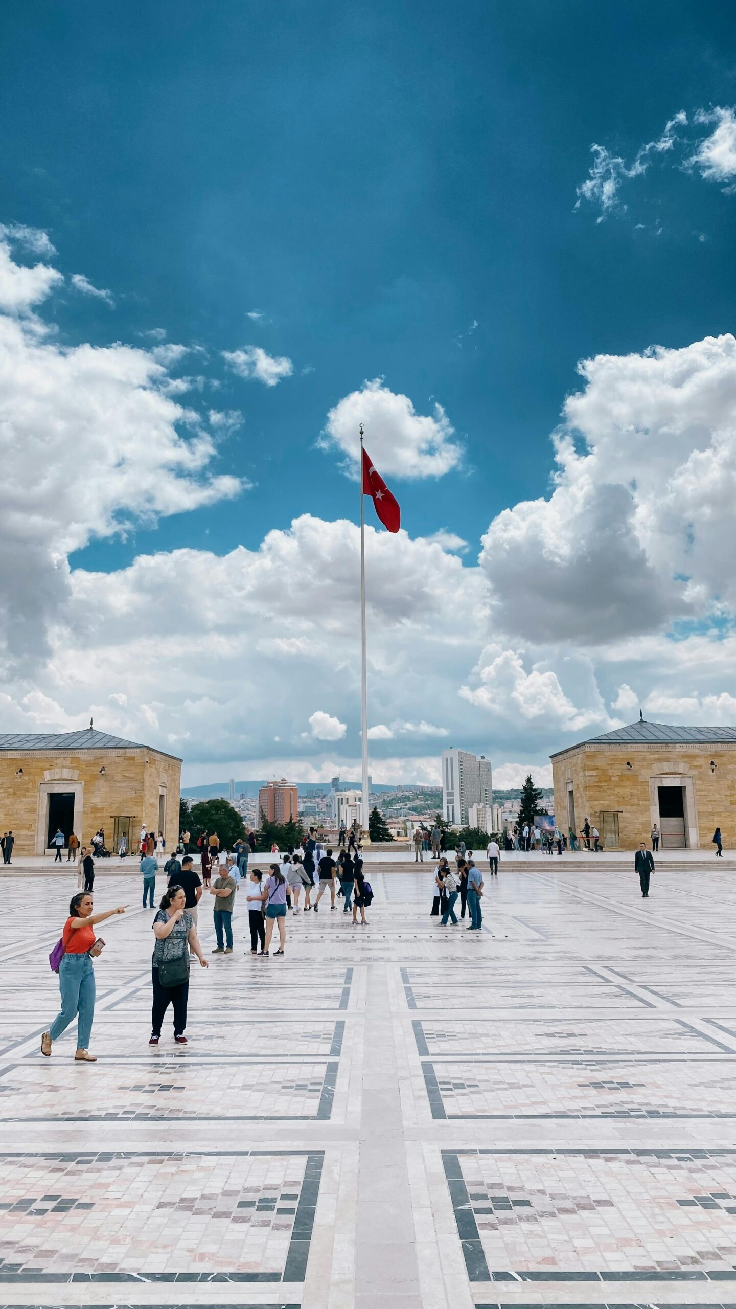 Visitors walking at Anıtkabir, the mausoleum of Mustafa Kemal Atatürk in Ankara, Türkiye, with a clear sky.